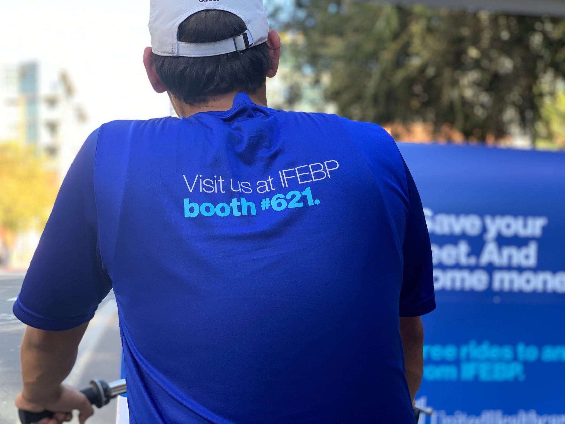 Branded pedicab driver shirt promoting IFEBP booth at convention