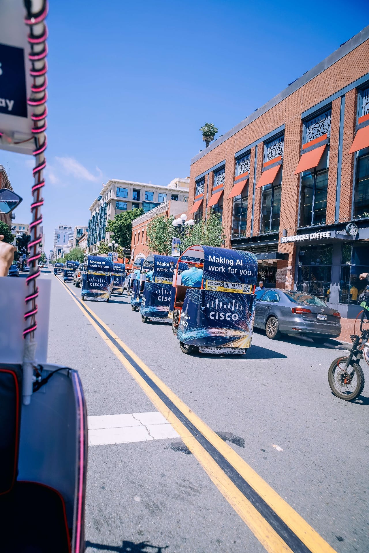 Cisco branded pedicab fleet cruising through Gaslamp Quarter San Diego