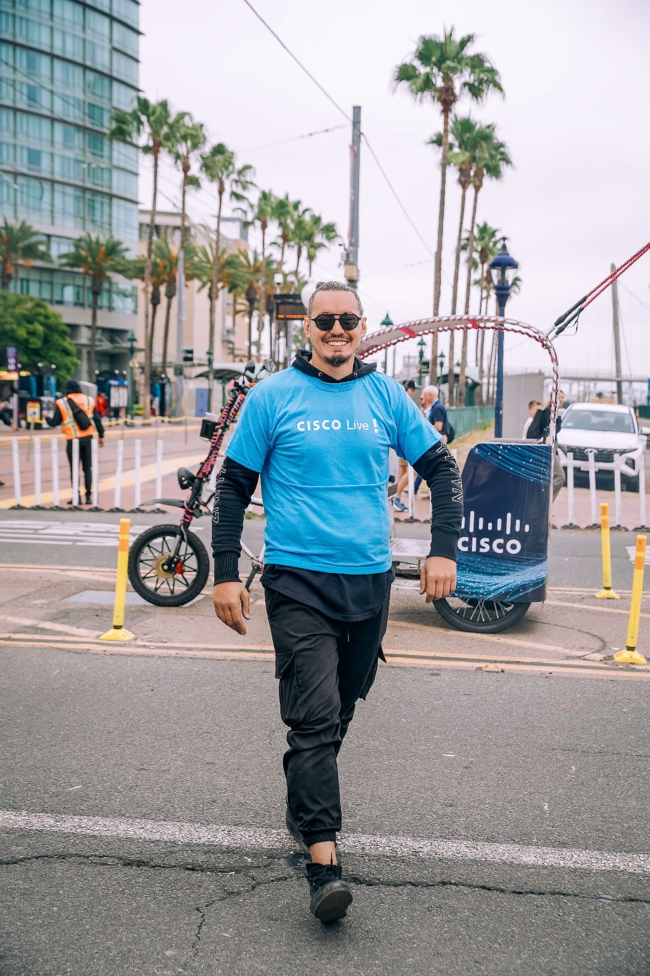Cisco Live branded pedicab driver with shirt near San Diego Convention Center