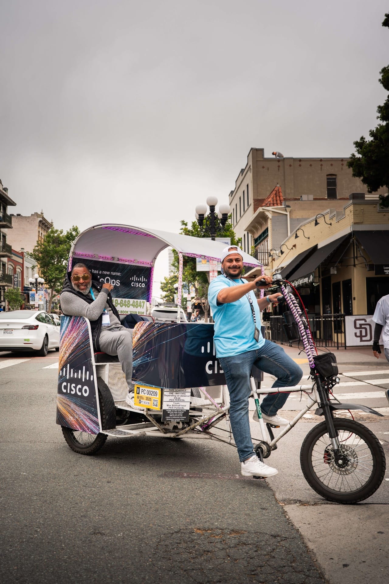 Cisco pedicab driver and happy passenger with sunglasses in Gaslamp Quarter