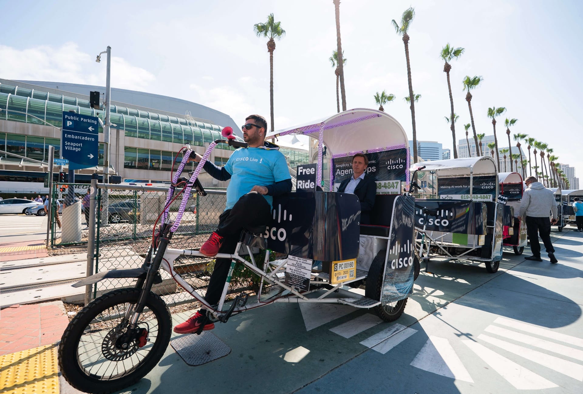 Cisco pedicab driver with free ride sign waiting for passengers
