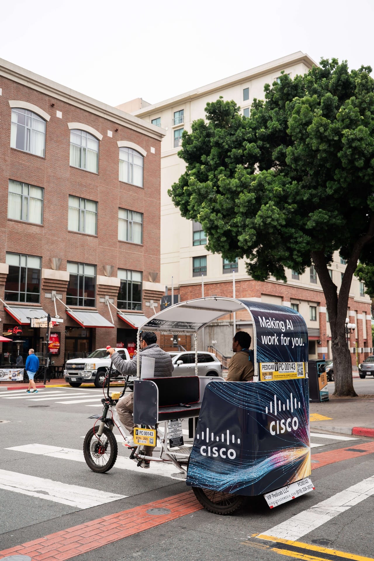 Cisco Making AI Work pedicab rear view at downtown crosswalk San Diego