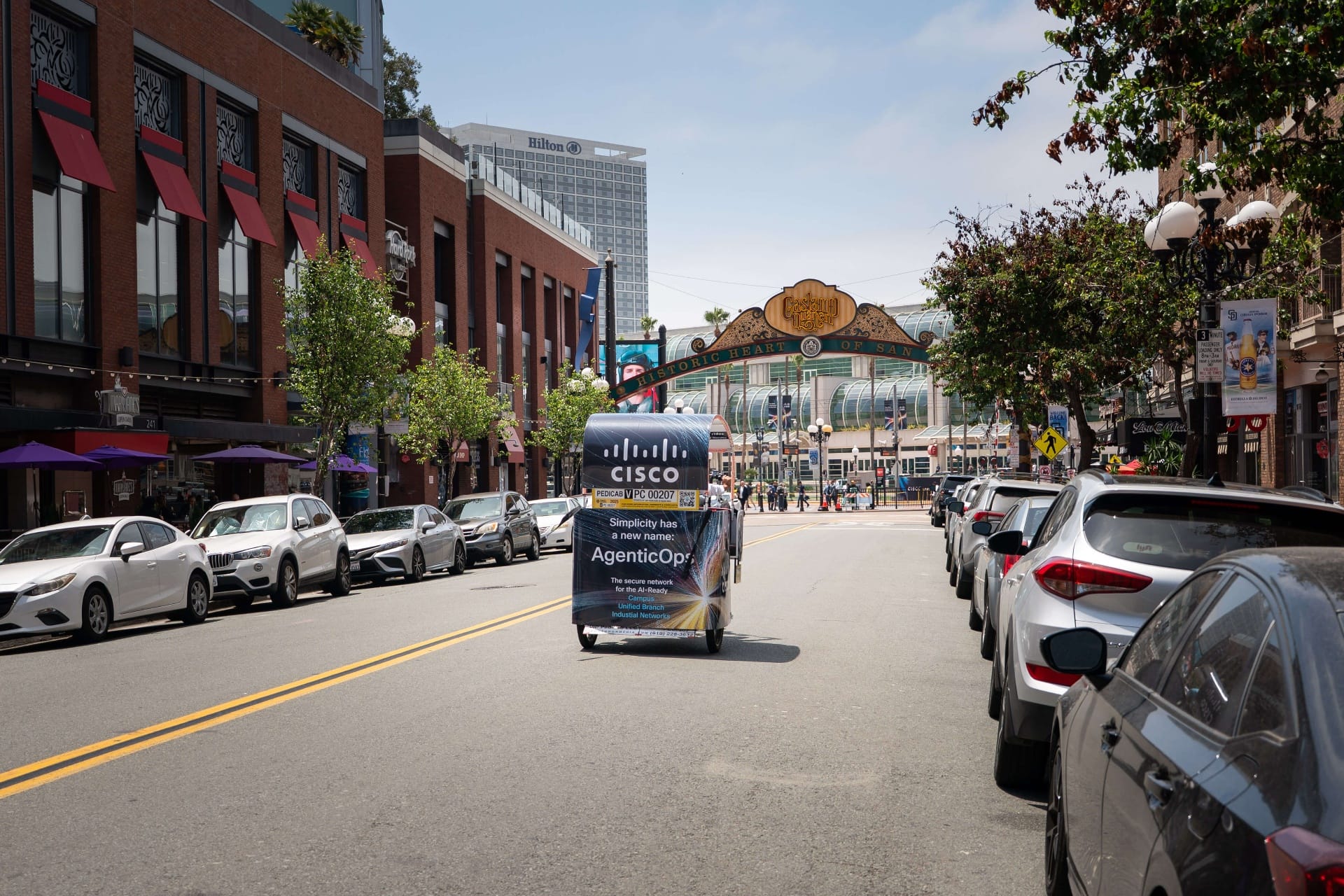 Action shot of Cisco pedicab fleet riding through downtown San Diego streets