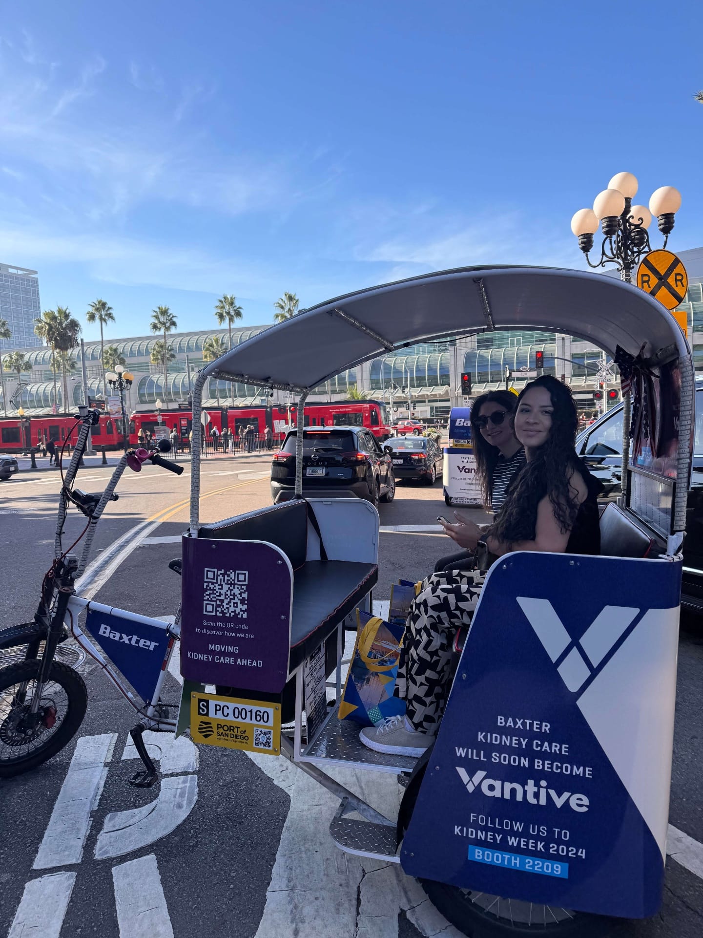 Happy passengers enjoying a pedicab ride through San Diego streets