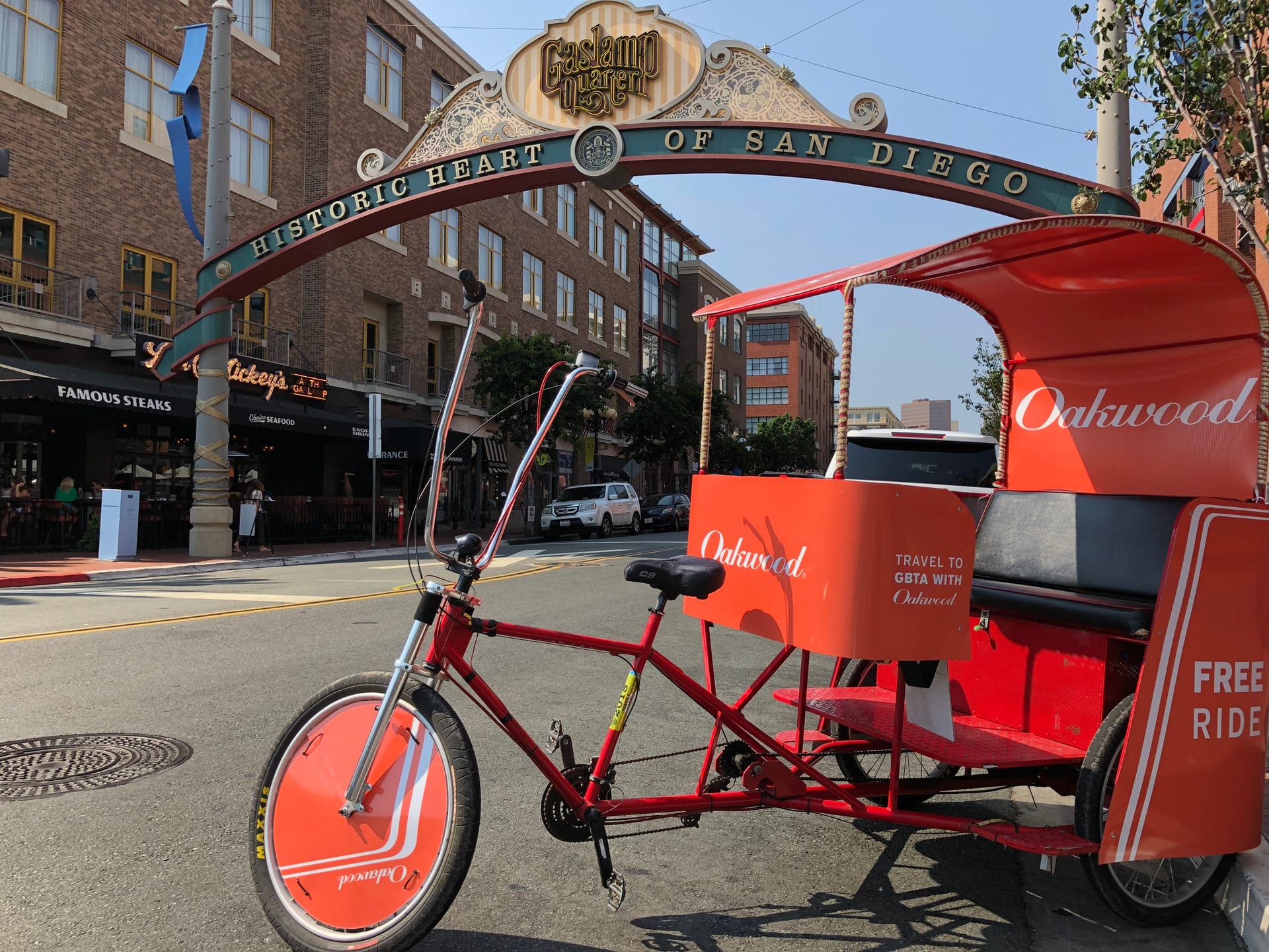 Oakwood branded pedicab at the Gaslamp Quarter sign in San Diego