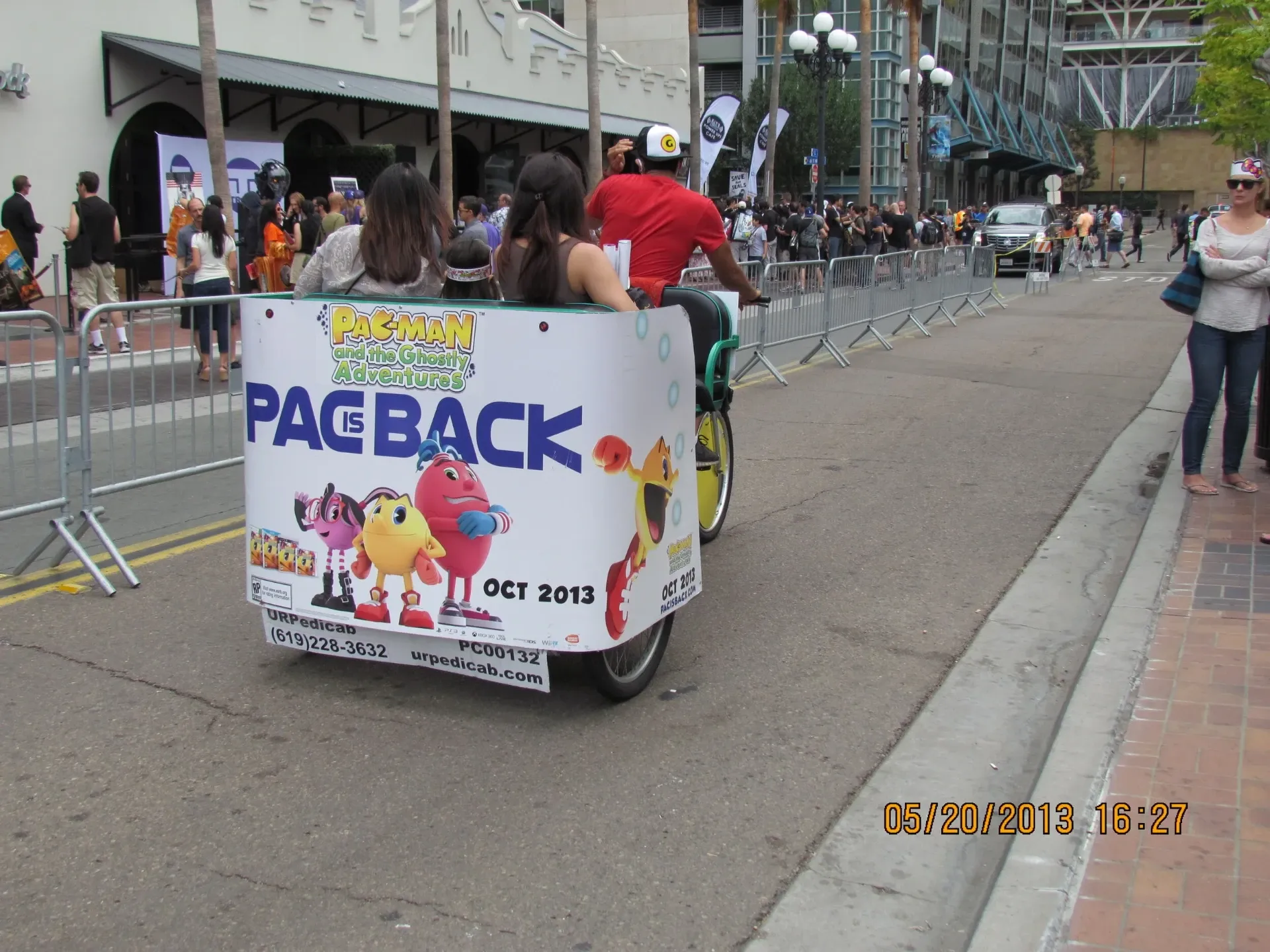 PAC-MAN branded pedicab with passengers at Convention Center Comic-Con