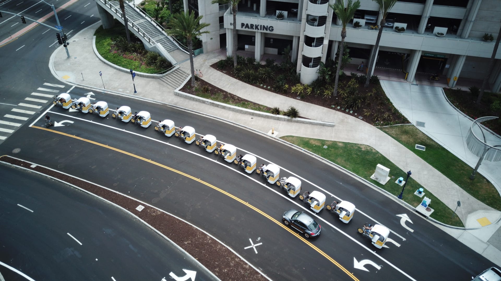 Aerial view of a branded pedicab fleet through downtown San Diego