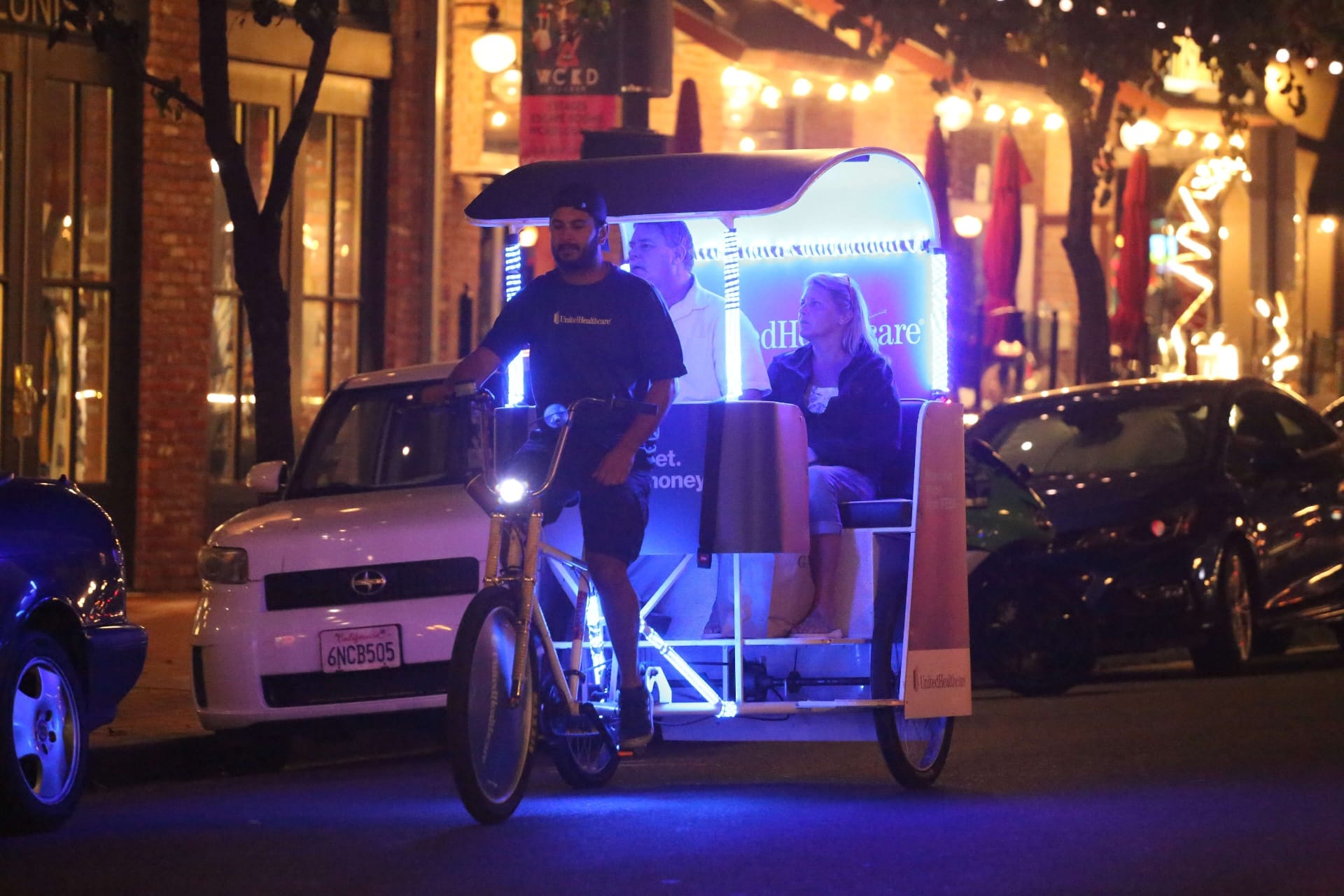 Pedicab nightlife ride through San Diego Gaslamp Quarter with city lights