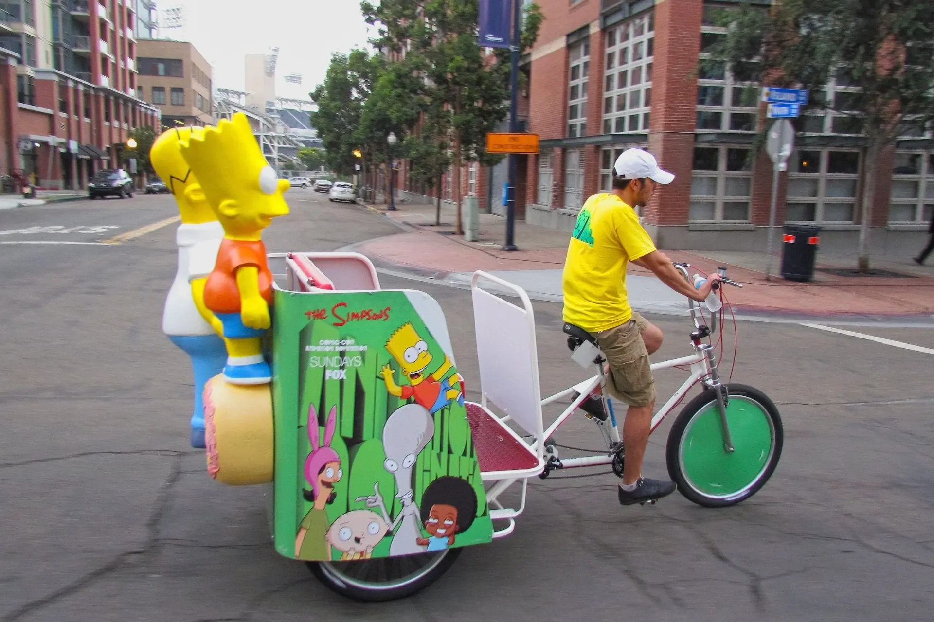 The Simpsons by Fox branded pedicab beside the Bart statue at Comic-Con