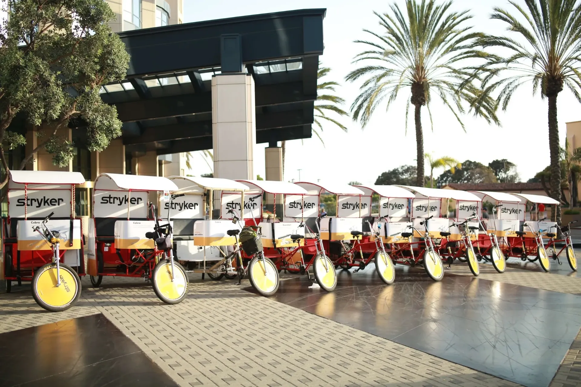 Stryker branded pedicab fleet lined up outside a San Diego hotel