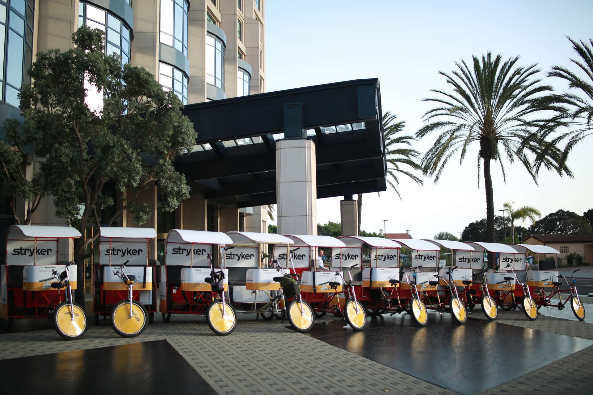 Stryker branded pedicab fleet outside a San Diego hotel