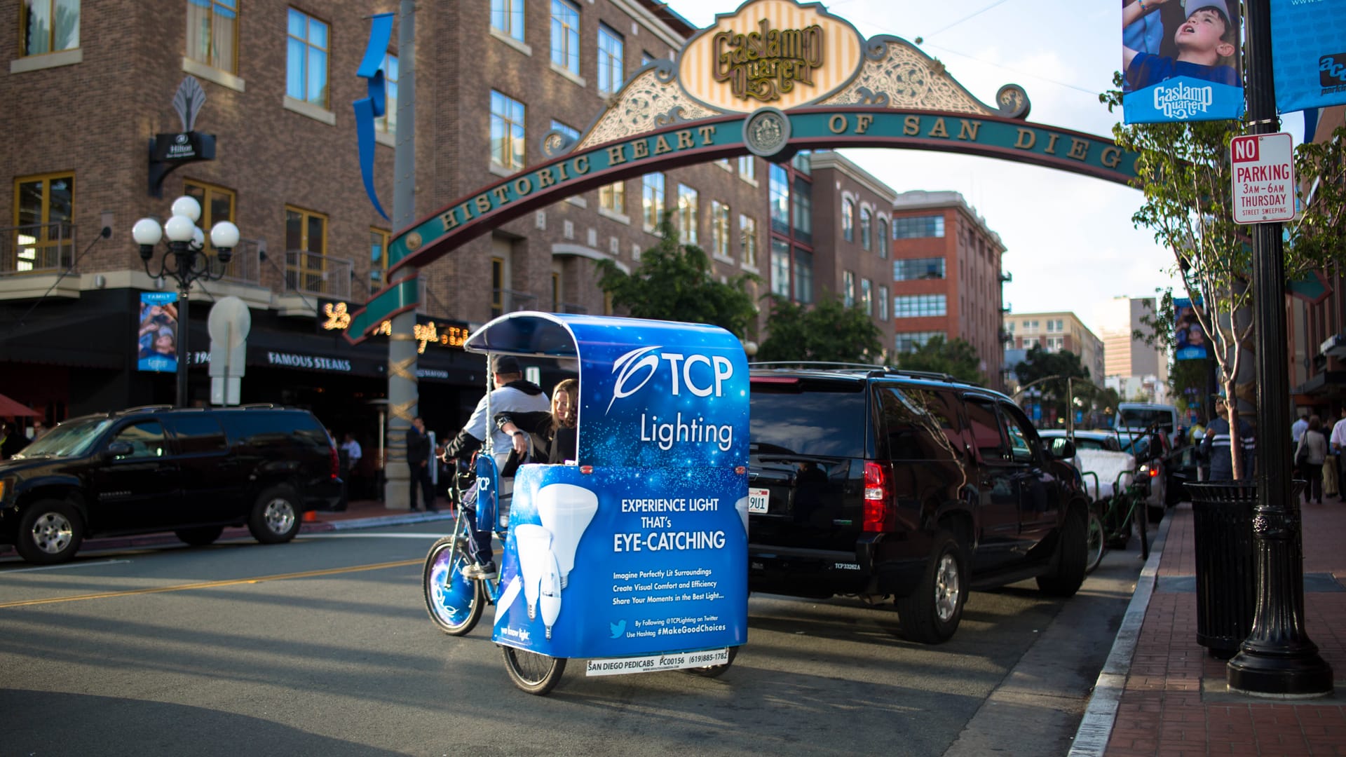 TCP Lighting branded pedicab under the Gaslamp Quarter sign in San Diego