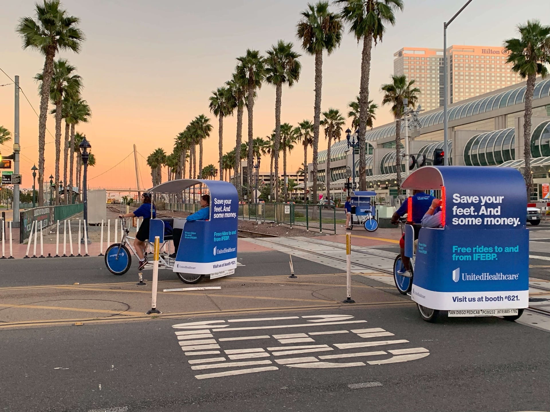 Healthcare-branded pedicab fleet at sunset by the San Diego Convention Center