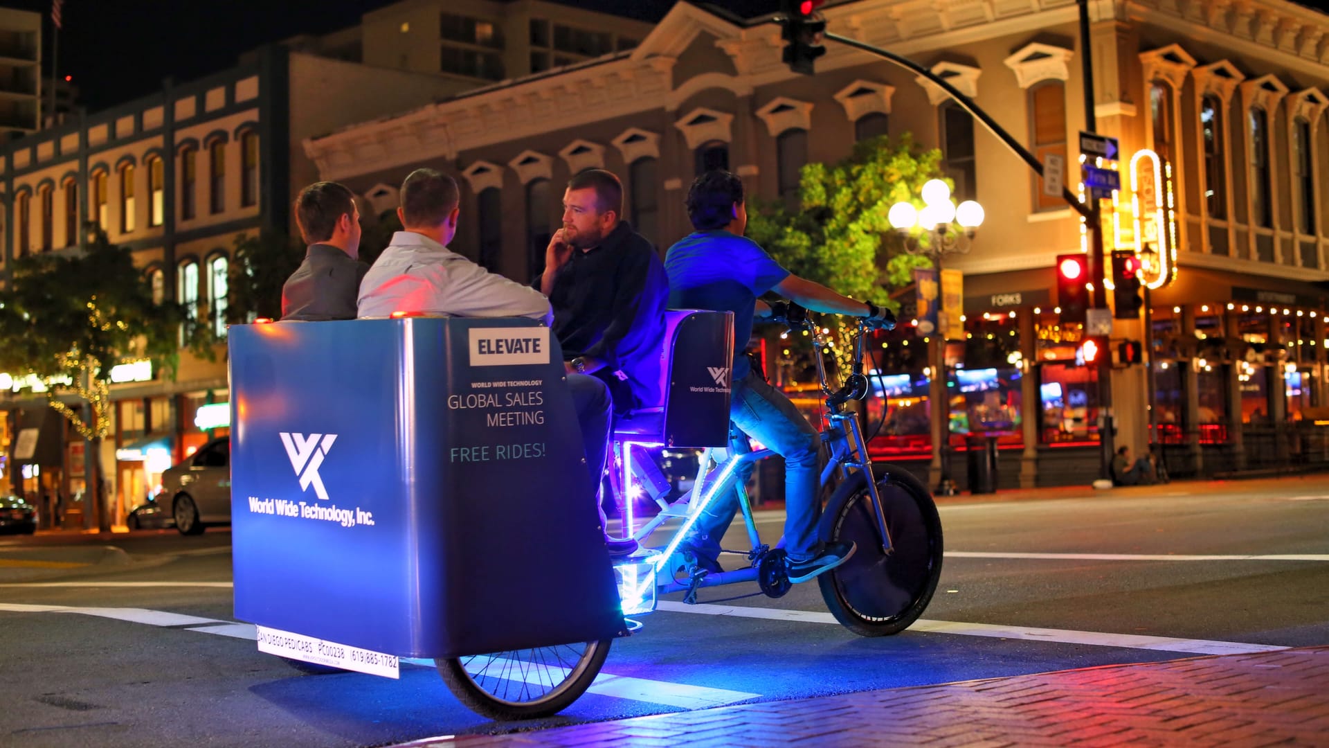 World Wide Technology branded LED pedicab at night in the Gaslamp Quarter